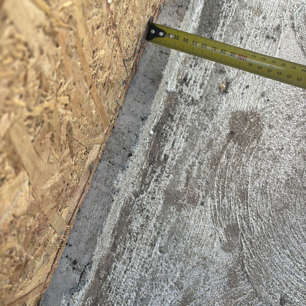 Slab edge sitting more than 20mm past the frame, narrowing the brick cavity, found during a frame inspection in Kalkallo