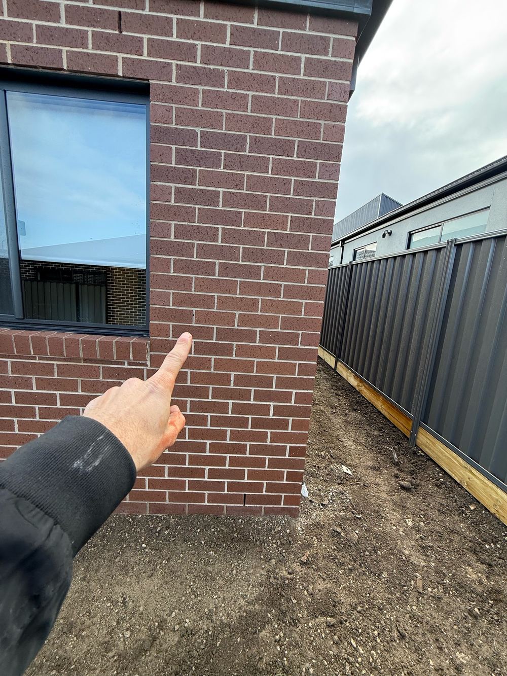 Holes and voids left in the mortar joints of the brickwork, found during a pre-handover inspection in Kalkallo